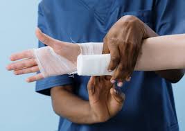 wound care showing a nurse wrapping a bandage on a patient arm