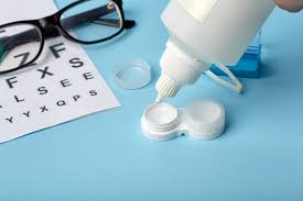 contact lens case with solution bottle and eye glasses and an eye chart