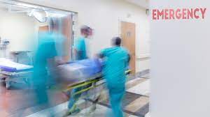 blurred image of three emergency nurses with a patient on a stretcher