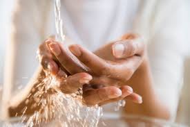 images of two hands under running water to practice hand hygiene